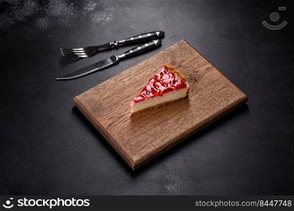 Piece of delicious homemade fresh strawberry pie on a holiday table. Delicious strawberry tart on concrete background, top view, copy space
