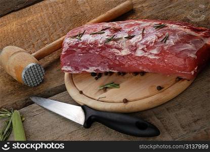 piece of fresh raw meat on cutting board
