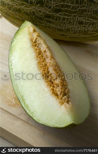Piece of fresh ripe juicy Piel de sapo melon and seeds