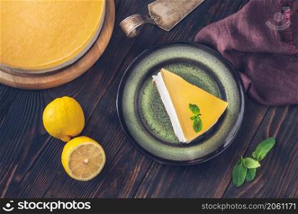 Piece of gin and tonic lemon cheesecake on rustic background