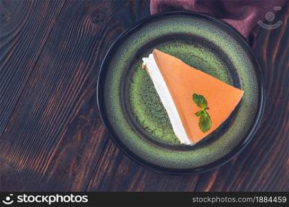 Piece of grapefruit cheesecake on rustic background