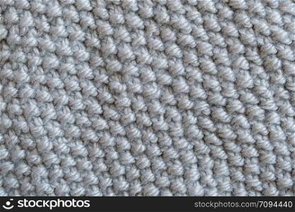 Piece of grey knitted fabric, Pearl Pattern Knitting. Background or texture.. Piece of grey knitted fabric, Pearl Pattern Knitting. Background or texture