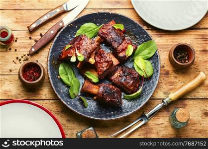 Piece of grilled beef ribs with a dark crust. Barbecue beef ribs,top view