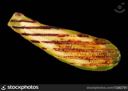 Piece of grilled zucchini on a black background. Piece of grilled zucchini on black