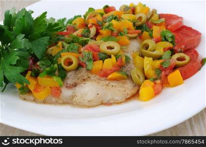 piece of juicy filet of fish with steamed vegetables