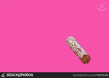 Piece of meat smoked bacon isolated on a pink background.