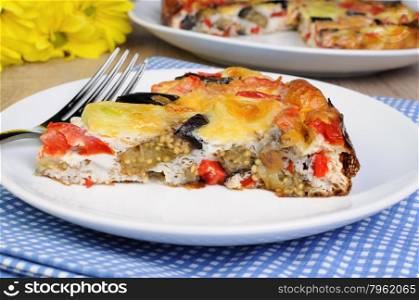 piece of omelette eggplant, leek, tomatoes and pepper with cheese
