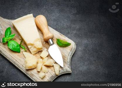 Piece of parmesan cheese isolated on concrete background or tab≤. Pieces of parmesan cheese on concrete background