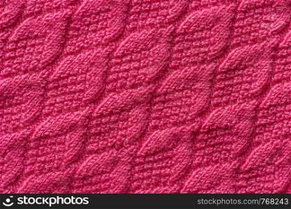 Piece of pink knitted fabric, background or texture. Knitting yarn handmade.. Piece of pink knitted fabric, background or texture. Knitting yarn handmade