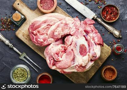 Piece of pork meat and a meat knife.Fresh pork with ingredients for cooking. Raw pork meat