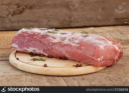 piece of raw meat on wood board