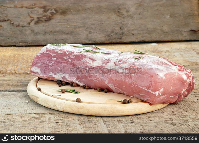 piece of raw meat on wood board