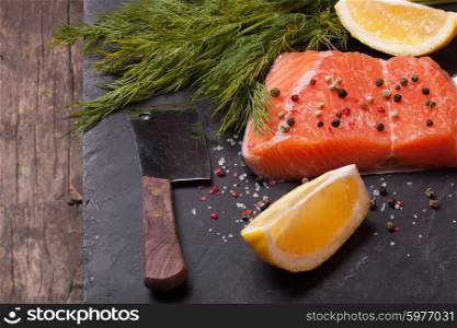 Piece of salmon with spices and lemon. Piece of salmon