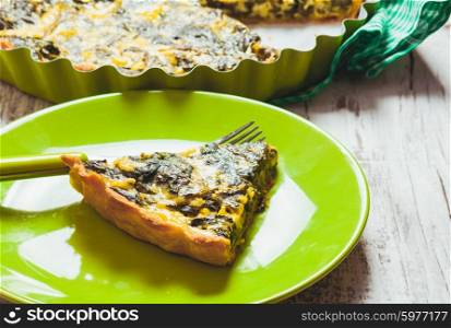 Piece of Spinach Tart on a green plate. The Spinach Tart