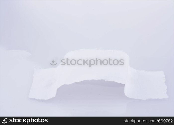 Piece of torn paper on a white background