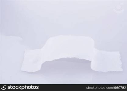 Piece of torn paper on a white background