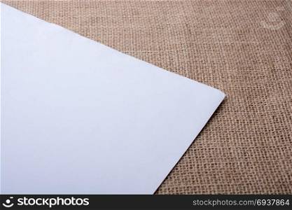 Piece of white paper placed on a linen canvas
