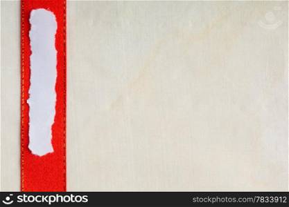 Piece scrap of white torn or ripped paper banner, blank copy space for text message red ribbon bright cloth background.