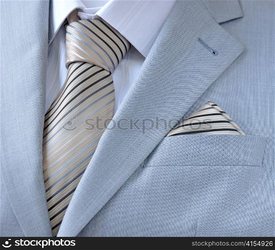 piece suit with white shirt, tie, scarf, close-up.