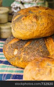 Pieces loaf of bread with poppy seeds. Ogranic, wheat made whole grain fresh food.. Pieces loaf of bread with poppy seeds