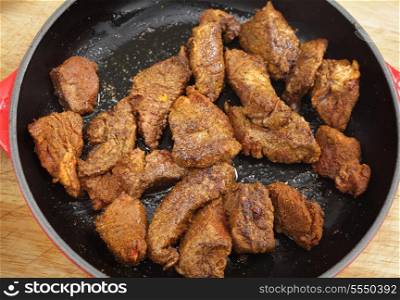 "Pieces of beef frying in olive oil after being rubbed in the mix of spices known as ras al hanout (literally "top of the shop") to make a Moroccan-style beef tagine"