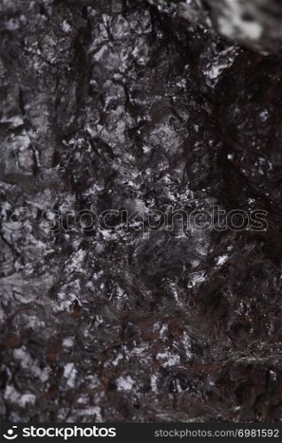 Pieces of black fossil coal texture background