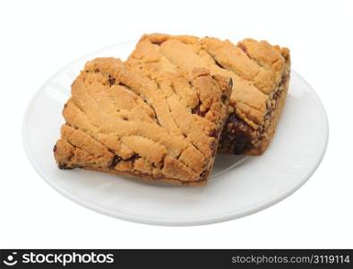 Pieces of brown sweet cookies on a white plate, isolated