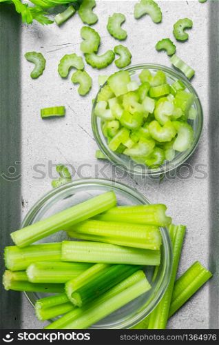 Pieces of celery in a bowl on a tray. Top view. Pieces of celery in a bowl on a tray.