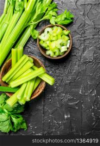 Pieces of celery in a wooden bowl. On rustic background. Pieces of celery in a wooden bowl.