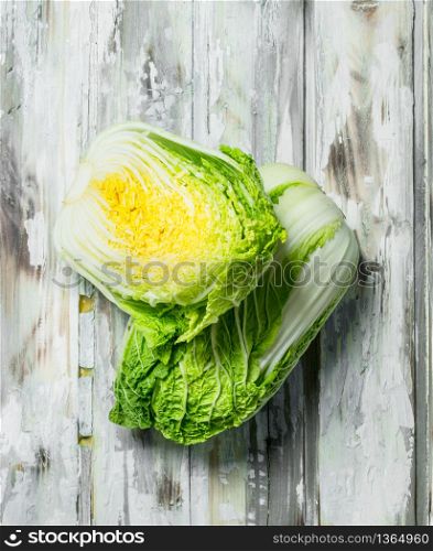 Pieces of Chinese cabbage. On a wooden background.. Pieces of Chinese cabbage.