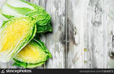 Pieces of Chinese cabbage. On a wooden background.. Pieces of Chinese cabbage.