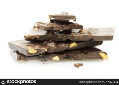 pieces of chocolate with nuts and raisins folded mountain, isolated on white