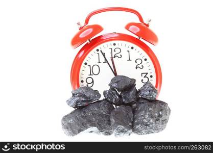 Pieces of coal and red clock isolated on white background