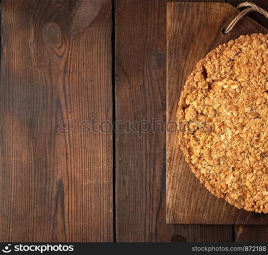 pieces of crumble pie with apples on a brown wooden board, copy space