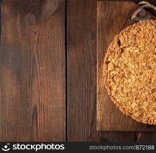 pieces of crumble pie with apples on a brown wooden board, copy space