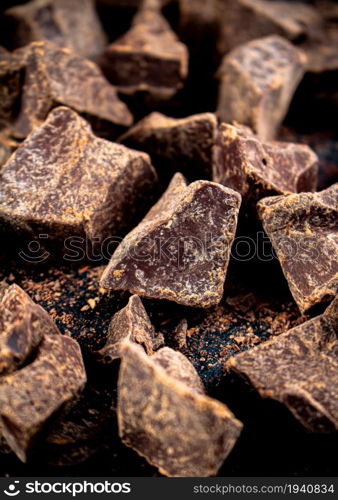 Pieces of dark chocolate. On a dark background. Chocolate texture.. Pieces of dark chocolate. Chocolate texture.