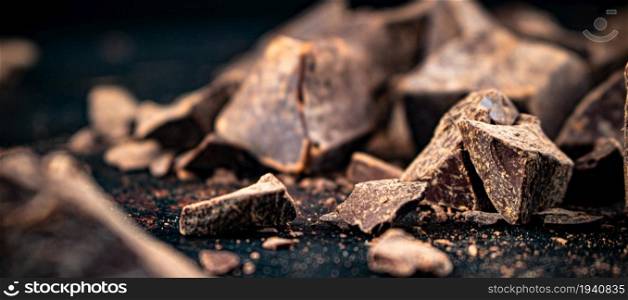 Pieces of dark chocolate. On a dark background. Chocolate texture.. Pieces of dark chocolate. Chocolate texture.