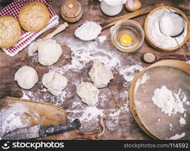 pieces of dough made from wheat flour on a brown table and ingredients