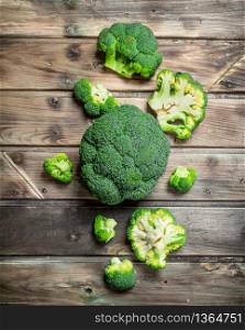 Pieces of fresh broccoli. On a wooden background.. Pieces of fresh broccoli.