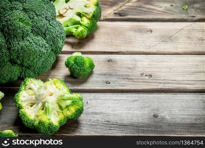 Pieces of fresh broccoli. On a wooden background.. Pieces of fresh broccoli.