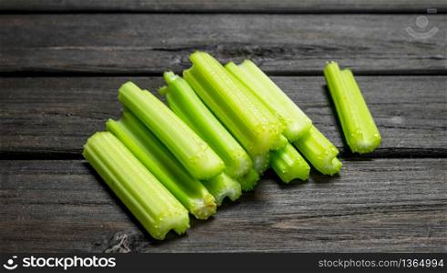 Pieces of fresh celery. On wooden background. Pieces of fresh celery.