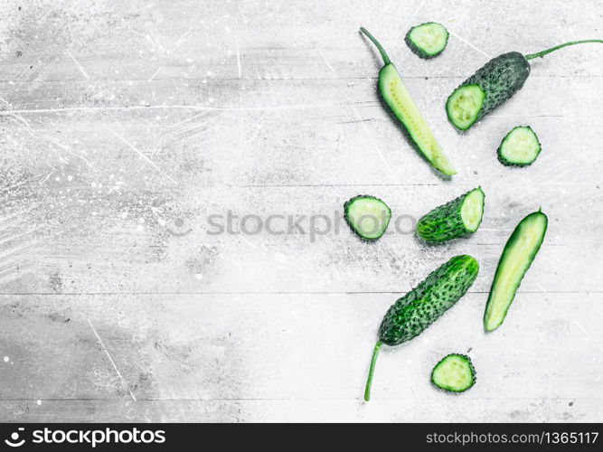 Pieces of fresh cucumbers. On rustic background. Pieces of fresh cucumbers.