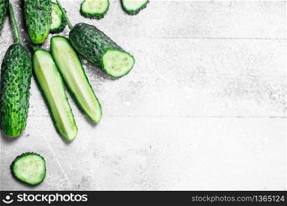 Pieces of fresh cucumbers. On rustic background. Pieces of fresh cucumbers.