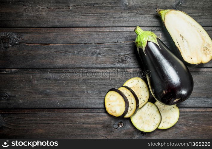 Pieces of fresh eggplant. On wooden background. Pieces of fresh eggplant.