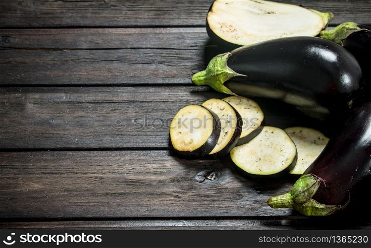 Pieces of fresh eggplant. On wooden background. Pieces of fresh eggplant.