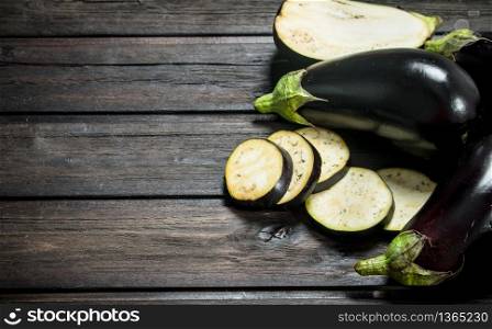 Pieces of fresh eggplant. On wooden background. Pieces of fresh eggplant.