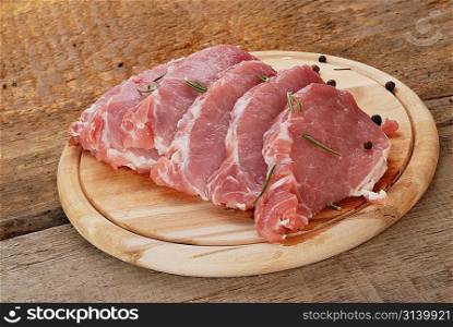 pieces of fresh raw meat on cutting board