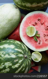 pieces of fresh watermelon as background with slice lime and mint. pieces of fresh watermelon as background