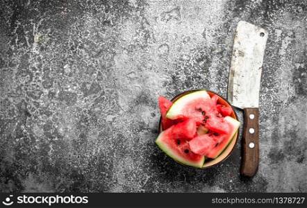Pieces of fresh watermelon in a bowl. On a rustic background.. Pieces of fresh watermelon in a bowl.