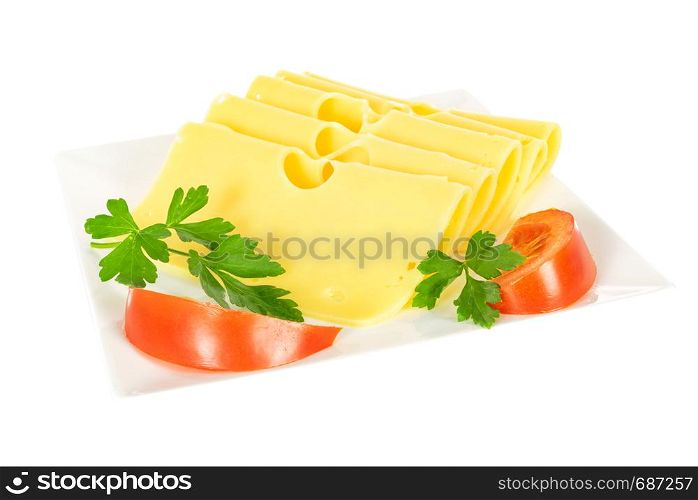 Pieces of fresh yellow cheese with parsley and tomatoes on a plate isolated on a white background in close-up.